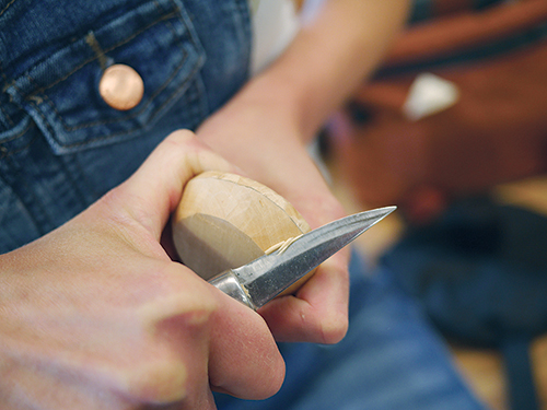 The author left a 1/8” flat on the side of the bottom piece and then carved an angle before fitting it into her groove.