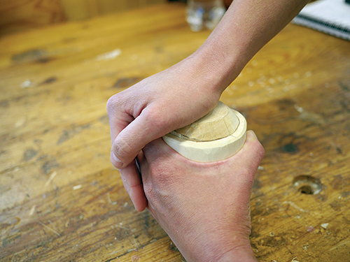 Finally, use your palm to apply pressure and pop the box bottom into place. The alignment mark acts as a guide for the custom fit.