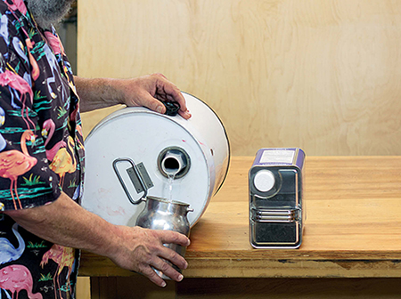 Pour from full cans with the spout at the top. Lay large round cans on the bench and roll them until a smooth flow starts.