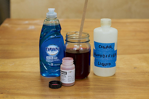 To a pint of water-soluble dye, add 10 drops of Dawn or an ounce of cigar humidifier liquid to make it flow better and get down into large wood pores.