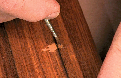 As you touch up a patch, your goal is to paint a picture of that particular wood onto the putty. A fine, sharp-tipped brush provides control as you paint in grain lines, moving from dark to light.