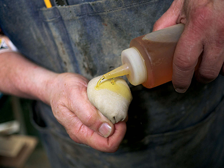 As the pad starts to dry out, add a few drops of finish to the surface of the pad