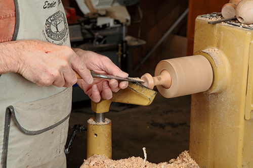 Scrape the cups to shape with a scraper while the work is held in a smaller version of a jam chuck.