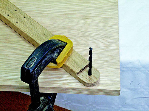 The same drill bit you used for boring the base and swivel arm holes can serve as a pin for aligning and clamping the parts for assembly.