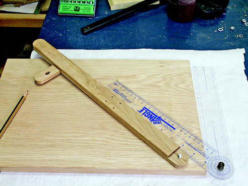 An angle finder, held against the edge of the jig base and swivel arm, establishes each pre-set angle setting you wish for the jig.