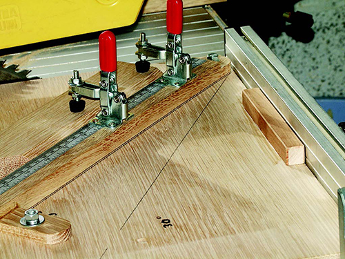 Once you’ve determined exact angle settings by making test cuts on scrap, draw lines on the jig base to mark the positions of the swivel arm.
