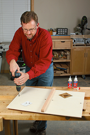 Drill shallow holes for four rare-earth magnets in the bottom panel, and cement them in with two-part epoxy.
