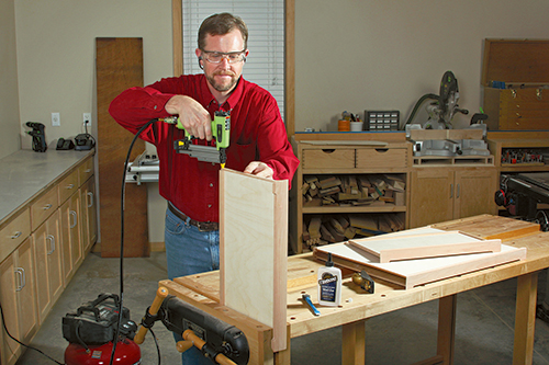 The author found a 23-gauge pin nailer helpful in keeping thin, narrow parts aligned as he glued and attached the tray sides flush with bottom faces of the tray panels.