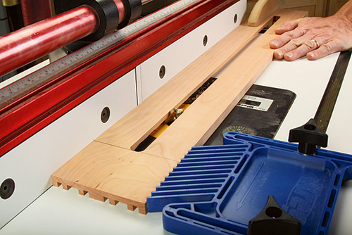 Rout a stopped channel along the workpiece to form curved feet on the housing sides.