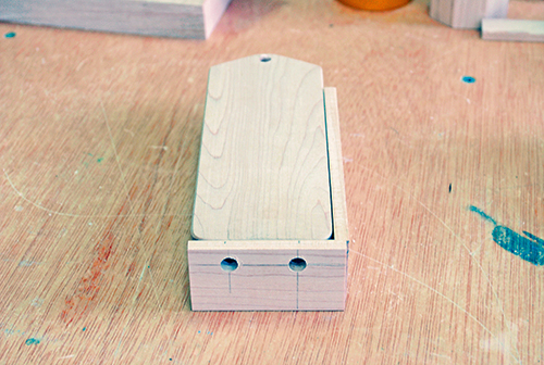 A third drilling jig was made with two holes through its end. This version locates the bases of the engine and endmost train car for drilling pairs of holes for bumpers.