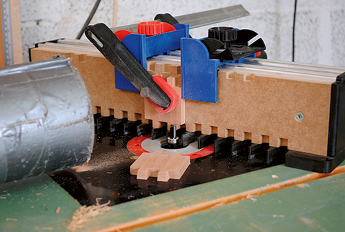 The author used a through dovetail jig made by Gifkins to form dovetails on his train car sides at the router table. You can use any dovetail jig you like, provided it can make a dovetail pattern small enough to suit the stock thickness here. Or, switch to box joints instead, if you prefer.
