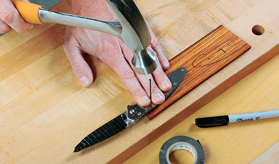 Trace the scale shapes and mark the screw hole locations with a finish nail or drill bit. Wrap the blade with thick tape first to protect yourself.