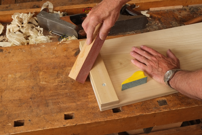 Gluing sheet sandpaper to a scrap wood block is great for breaking edges. A chamfered edge looks much better than a rounded one.