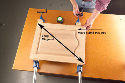 Square the door by racking the clamps in the same direction as the long diagonal and retightening them. This will gently pull the door square.