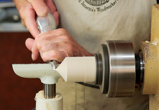Photo 1: Form a half cove and a rounded tip to create the bearing end on which the top spins.