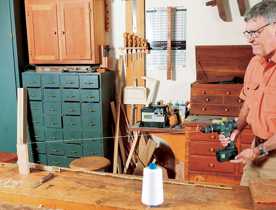 Ply two strands of 5/2 cotton thread into a Z twist to form a yo-yo string. A drill set on reverse speeds the twisting process along between two nails.