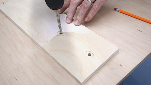 Drilling holes for inserting T-tracks into adjustable desk