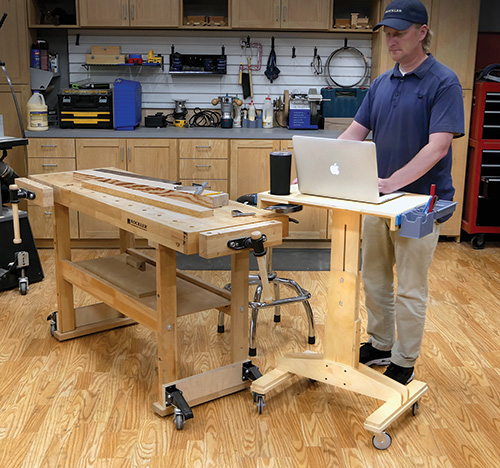 Using the adjustable desk in a workshop as a mobile laptop stand