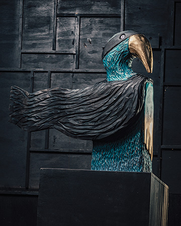 Bird sculpture with curved beak