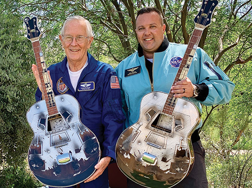 Astronaut Charlie Duke posing with guitar