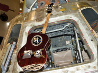 NASA Apollo-themed guitar next to Apollo space capsule