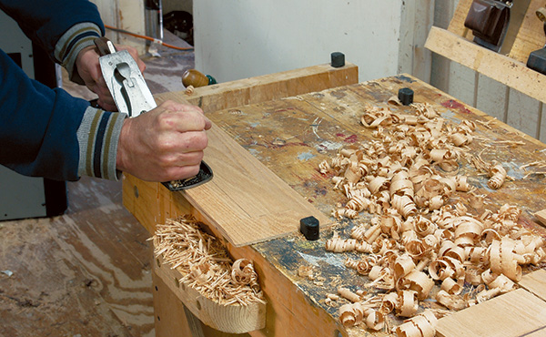 Shaving down entertainment center door panels with plane