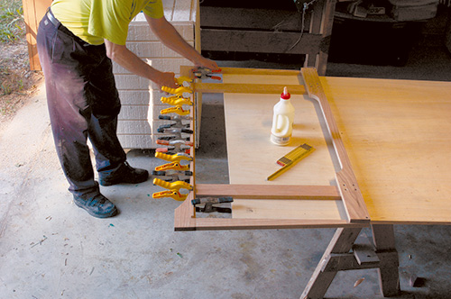 Gluing and attaching base assembly for entertainment center