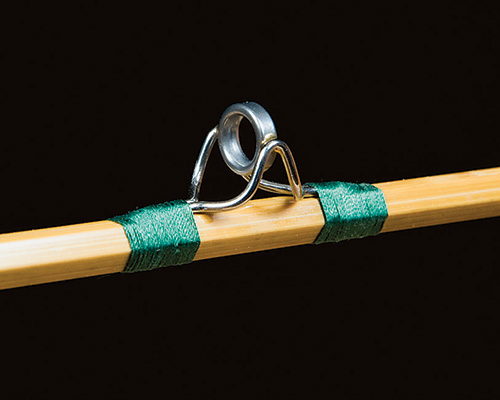Silk thread hold-down for fly fishing rod eyelets