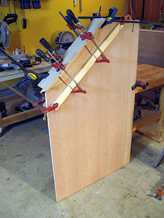 Attaching edging to desk side panel