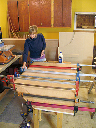 Using bar clamps to glue-up edging on desk panel