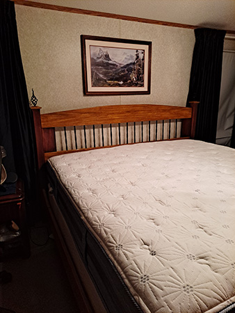 Corner view of King size wooden bedframe