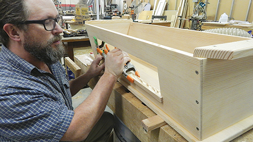 Once you’ve glued and clamped the window trim in place (above), you’ll have enough edge surface to cut and fasten the piano hinge (right) for hanging the window cover.