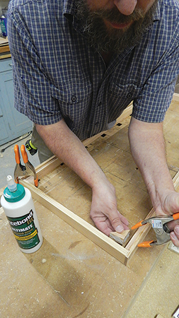 Assemble the lid frame and corner blocks with glue, screws and clamps. These blocks fit around the hive handles so the lid rests flat.