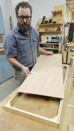 Cut the lid panel to size, then glue it into the rabbets in the frame assembly. The author used pin nails as fasteners.