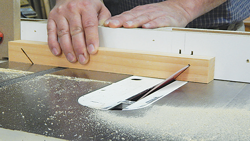 Cut the non-through end angles on the top bars at the table saw. Use your miter gauge and a stop block to control these cuts. Tilt the saw blade to 45°.