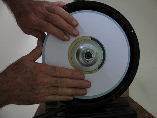 Attaching marking paper to side of bench grinder wheel