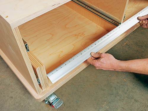 Measuring space for drawer installation in tool cart cabinet