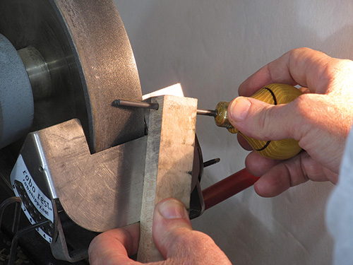 Sharpening tip of birdcage awl with a grinder