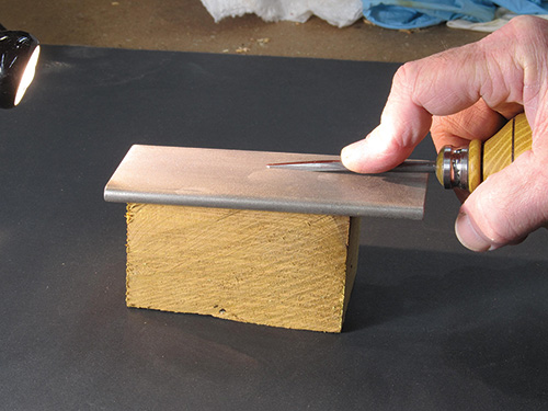 Sharpening birdcage awl with a sharpening stone