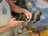 Demonstrating process for grinding a bowl gouge