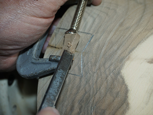 Using clamp to steady inlay during installation
