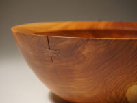 Crack in turned bowl repaired with butterfly inlay