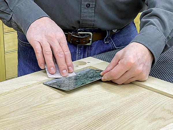 Protecting cabinet door during sanding with plastic laminate