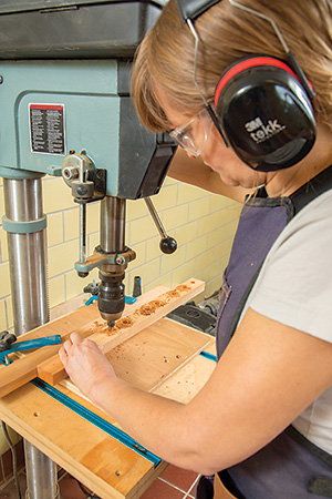 Drilling holes for installing cross brace for cedar potting bench