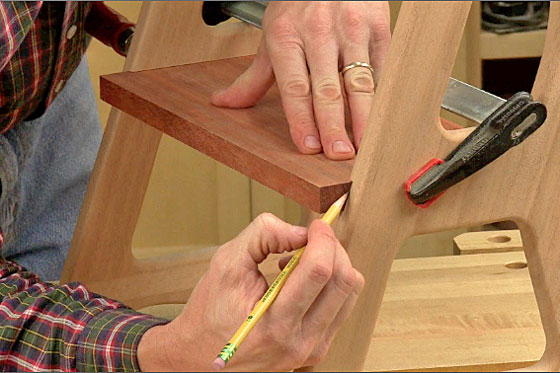 Figure 11: Slip the steps into their dadoes in the upper and lower sides, and mark their overhanging front edges. Trim off this waste at the table saw.