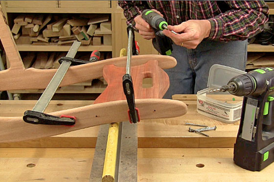 Figure 12: Clamp the chair back between the upper sides, trace its location and use these references for drilling the necessary screw pilot holes. Drive 1-1/2-in. screws into deep counterbores to secure the parts.