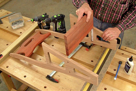 Figure 13: Spread glue into the dadoes for the third step, slip it into place, and secure it to the upper sides with counterbored screws.