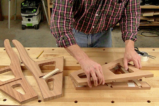 Figure 6: Use 1/2-in.-thick filler pieces, fitted in the dadoes, to align the upper and lower side pieces with their rough-cut counterparts. Stick the pairs together with double-sided tape.