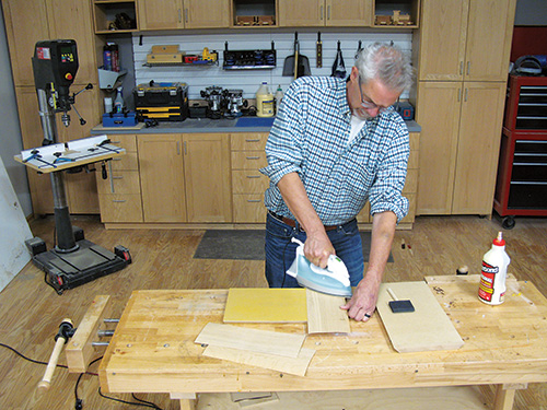 Ironing veneer to panel to activate glue