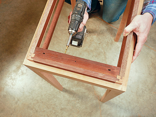 Screwing cleats into wine cabinet framework